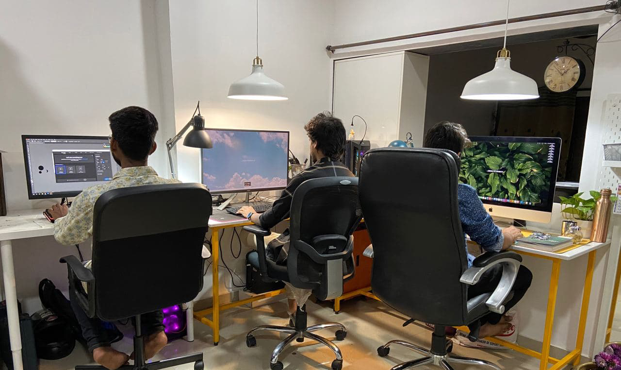the absolute design studio interior with employee working on windows and mac